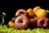 Fruits and vegetables on green moss background.