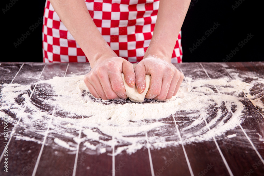 Cook preparing dough for baking in the kitchen Cook preparing dough for baking in the kitchen