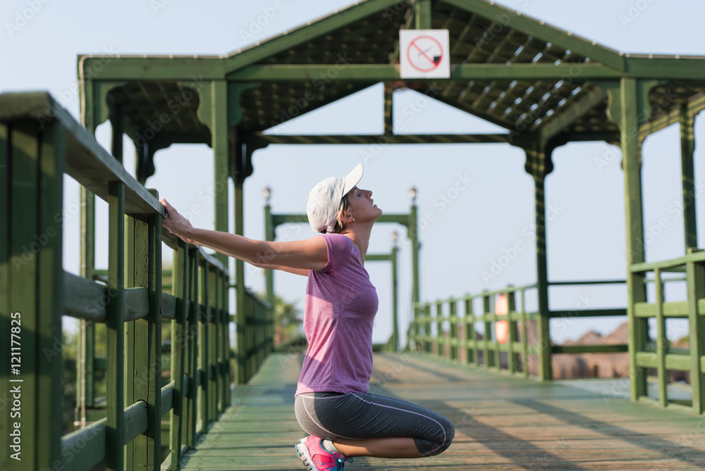 woman stretching before morning jogging woman stretching before morning jogging