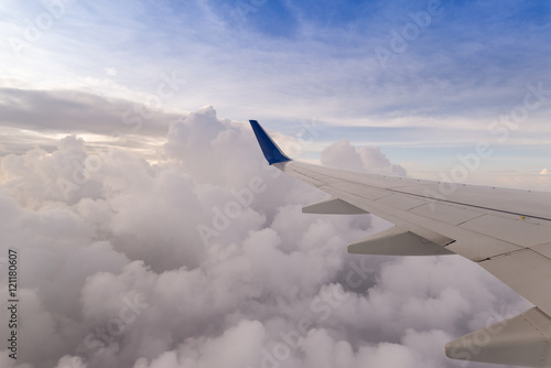 Clouds and sky as seen through window of an aircraft. Looking th