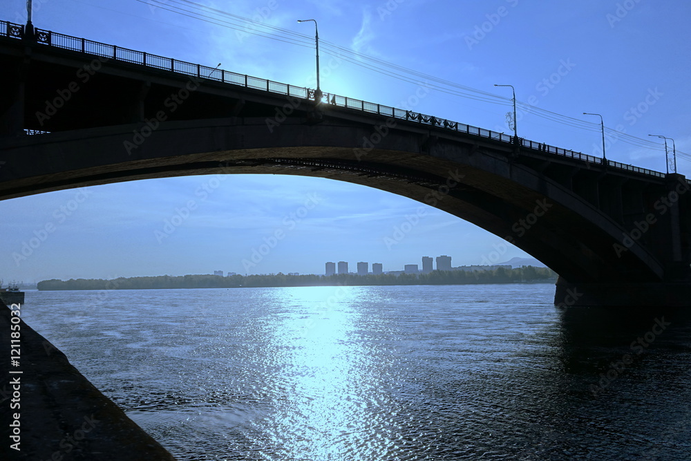 cityscape with bridge on the river at dawn, backlight