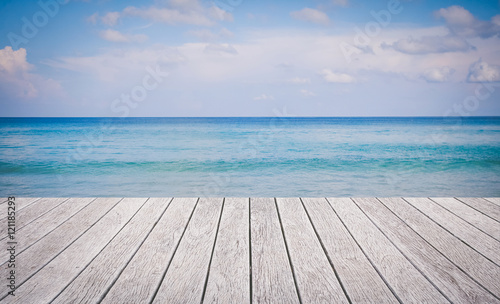 Wooden floor with beautiful ocean and blue sky