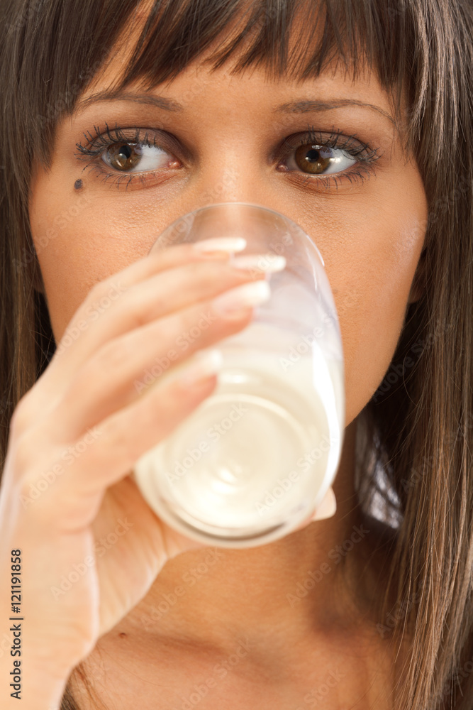Portrait of young woman drinking milk isolated on white backgrou Portrait of young woman drinking milk isolated on white backgrou