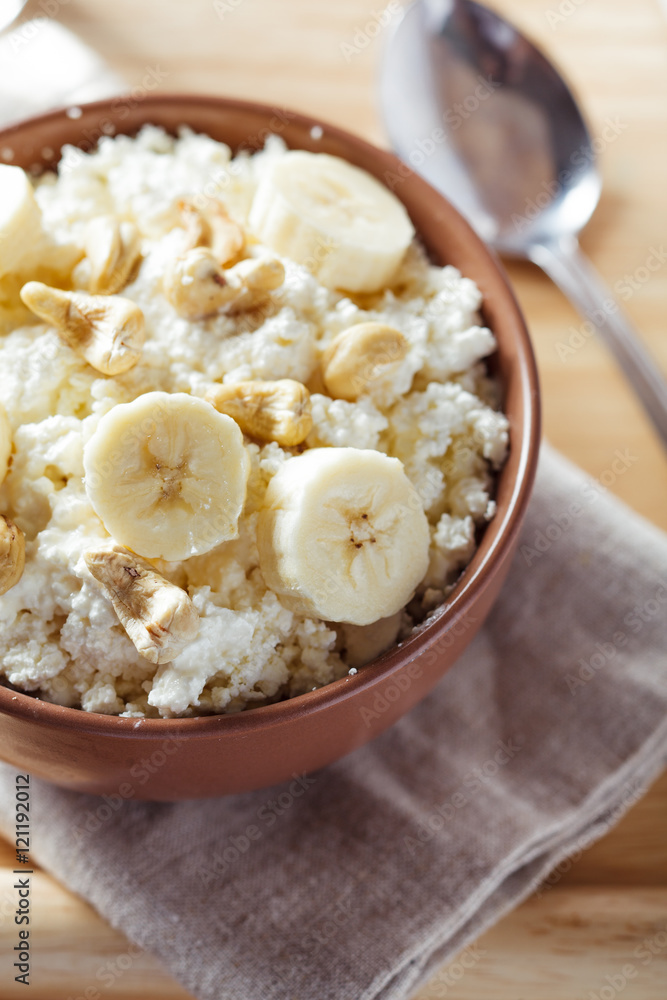 Close-up view of bowl with cottage cheese, banana and nuts