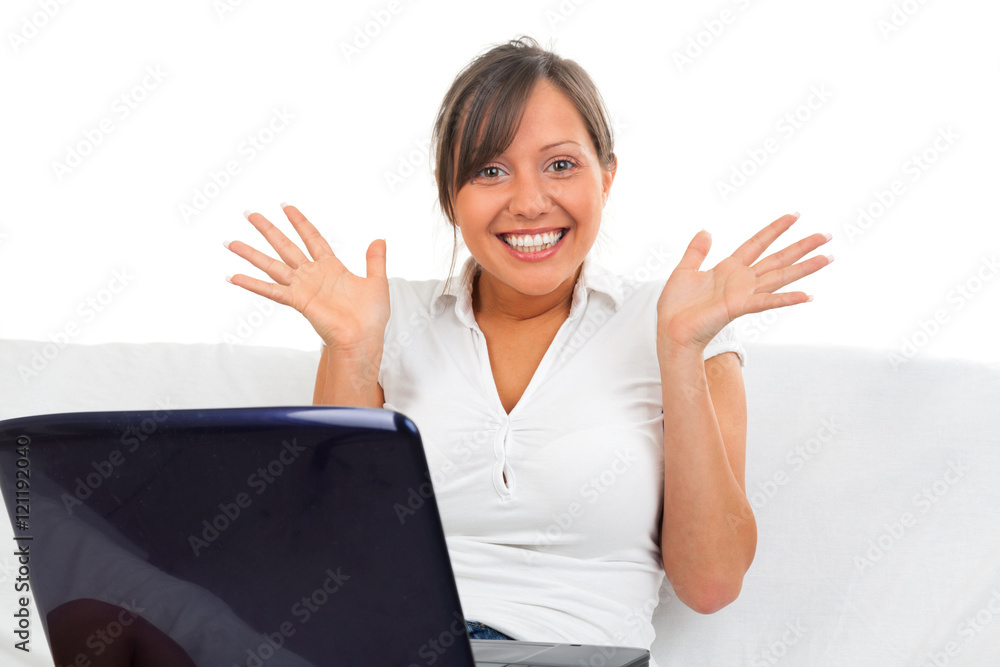 Young woman sitting on a sofa and working with a laptop Young woman sitting on a sofa and working with a laptop