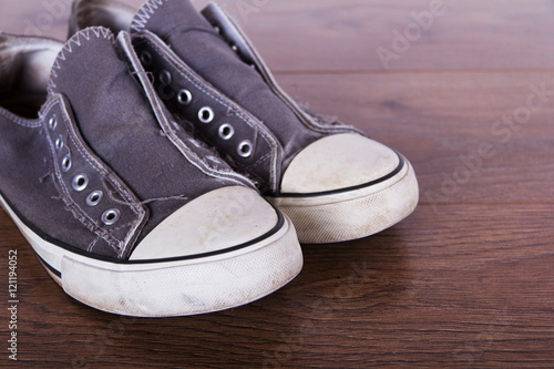 Old canvas shoes on a wooden floor