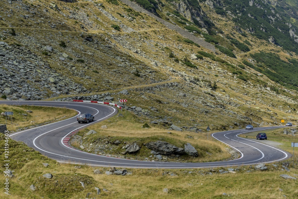 Mountain landscape with road and moving cars. Transfagarasan mountain road landscape.