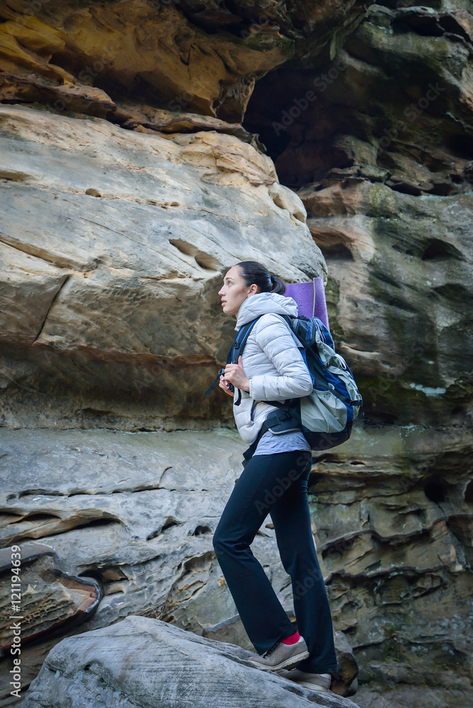 Woman hiker walking with backpack big rock at background Woman hiker walking with backpack big rock at background
