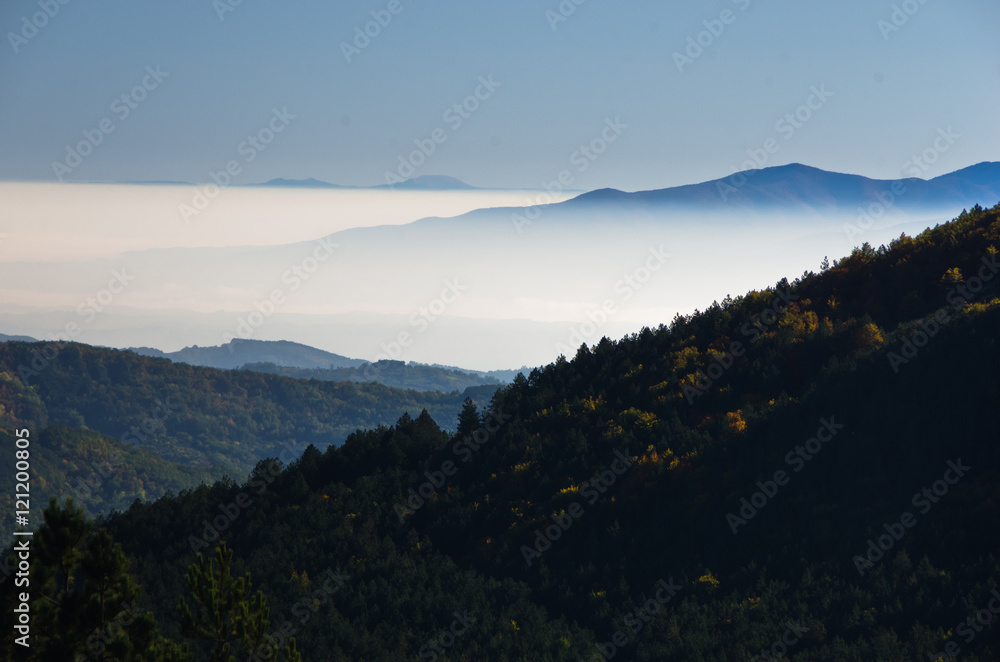 Autumn fog is rolling between hills of Zeljin mountain, Serbia