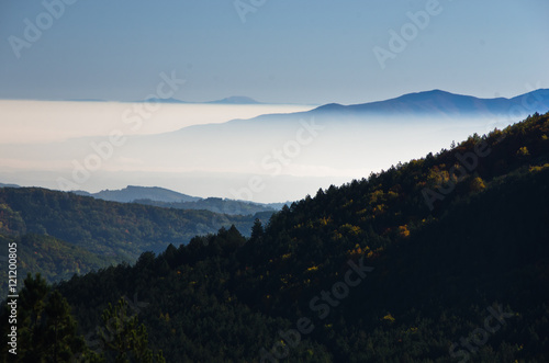 Autumn fog is rolling between hills of Zeljin mountain  Serbia