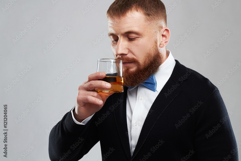 stylish handsome bearded man enjoying a brandy or whiskey.drinking a alcohol stylish handsome bearded man enjoying a brandy or whiskey.drinking a alcohol