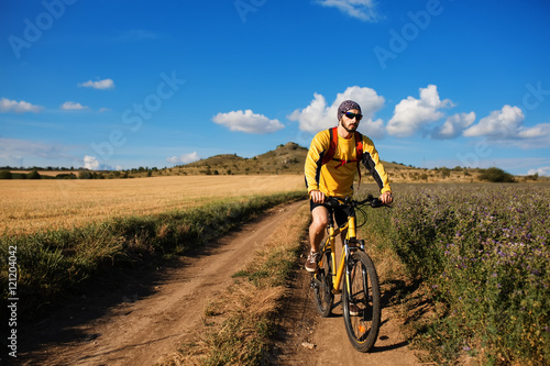 Cyclist Riding the Bike on the Trail © Aleksey