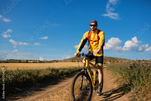 Cyclist Riding the Bike on the Trail