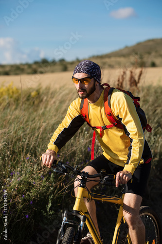 Cyclist Riding the Bike on the Trail