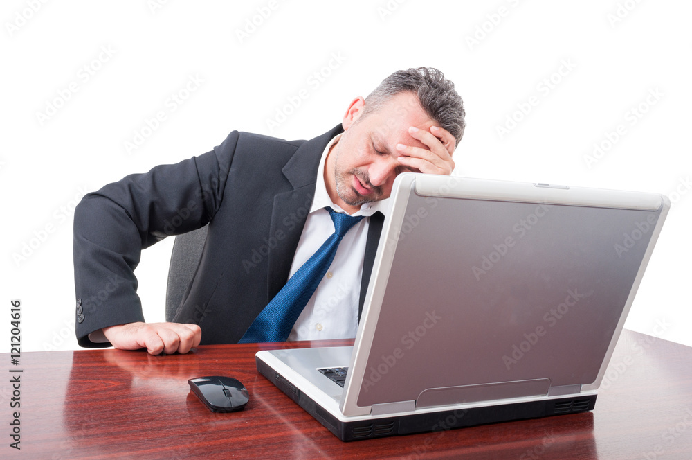 Man wearing suit at office being very tired Man wearing suit at office being very tired
