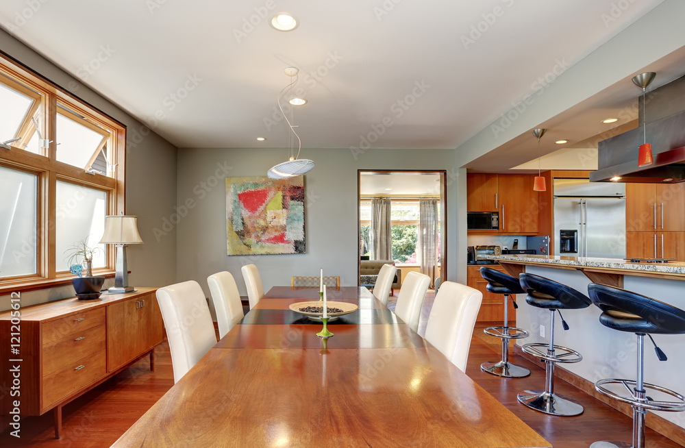 Large wooden dining table with white chairs in cozy house Large wooden dining table with white chairs in cozy house