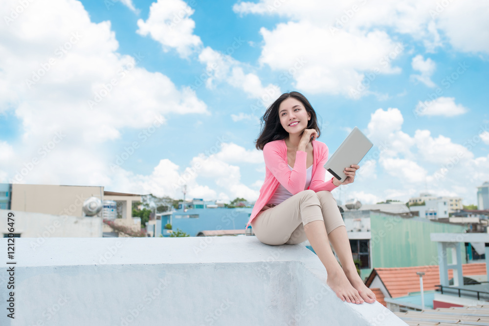 Freedom concept. Enjoyment. Asian young woman relaxing under blu Freedom concept. Enjoyment. Asian young woman relaxing under blu