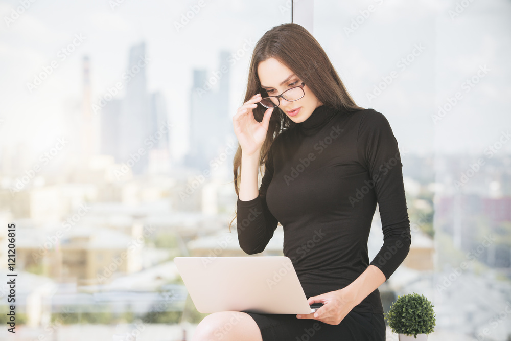 Young female using laptop computer Young female using laptop computer