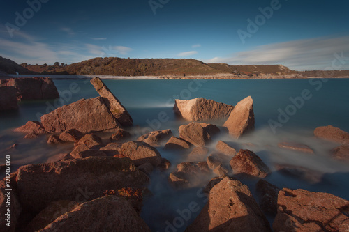 View of Pwll Du Bay from the headland, on the Gower peninsula in South Wales, mainly covered in pebbles, used to be an extensive limestone quarry and also a popular smuggling cove.
 photo