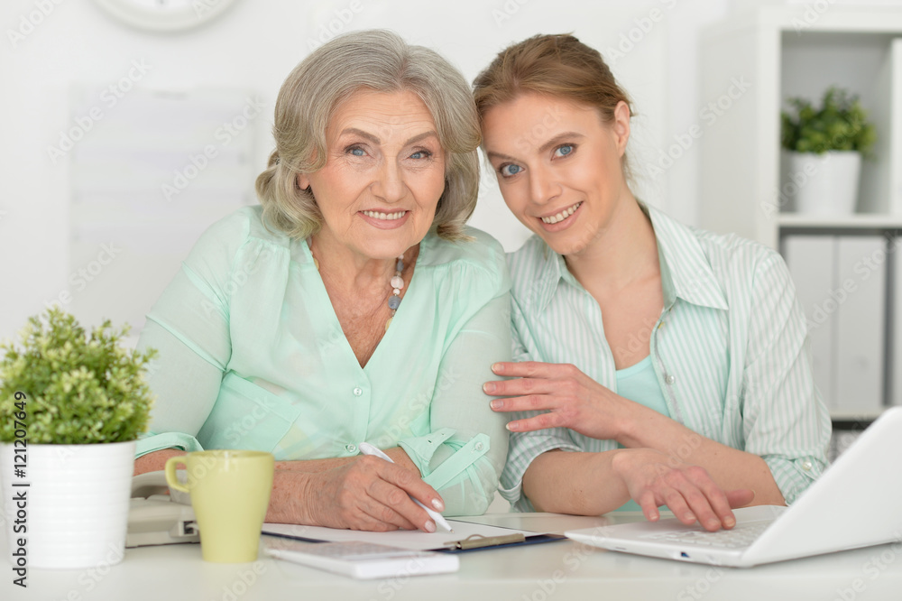 mother and adult daughter with laptop mother and adult daughter with laptop