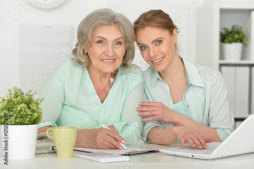  mother and adult daughter with laptop