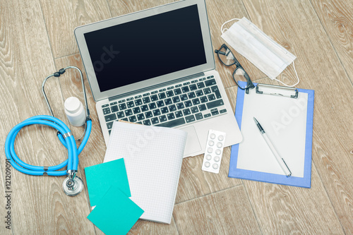 Stethoscope on laptop, close-up