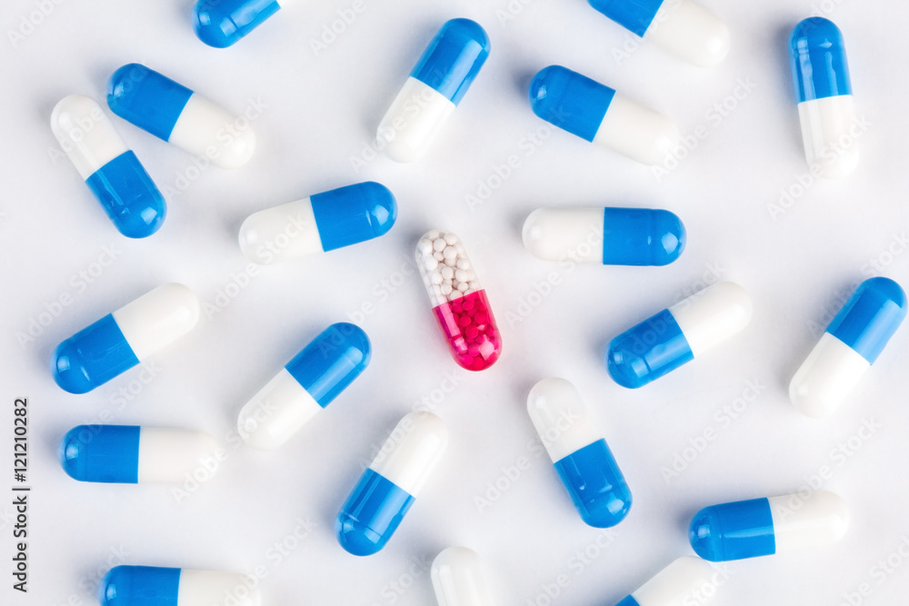 Blue capsules around pink capsule Blue capsules around pink capsule