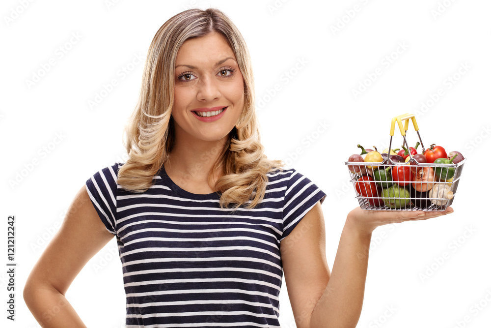Woman holding basket full of fruits and vegetables Woman holding basket full of fruits and vegetables