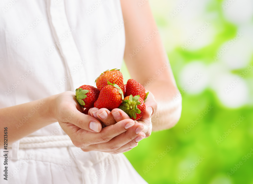 Fresh ripe red juicy strawberries in hands of young woman Fresh ripe red juicy strawberries in hands of young woman