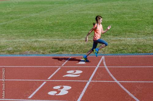 Kids sport, child running on stadium track, training and fitness concept 