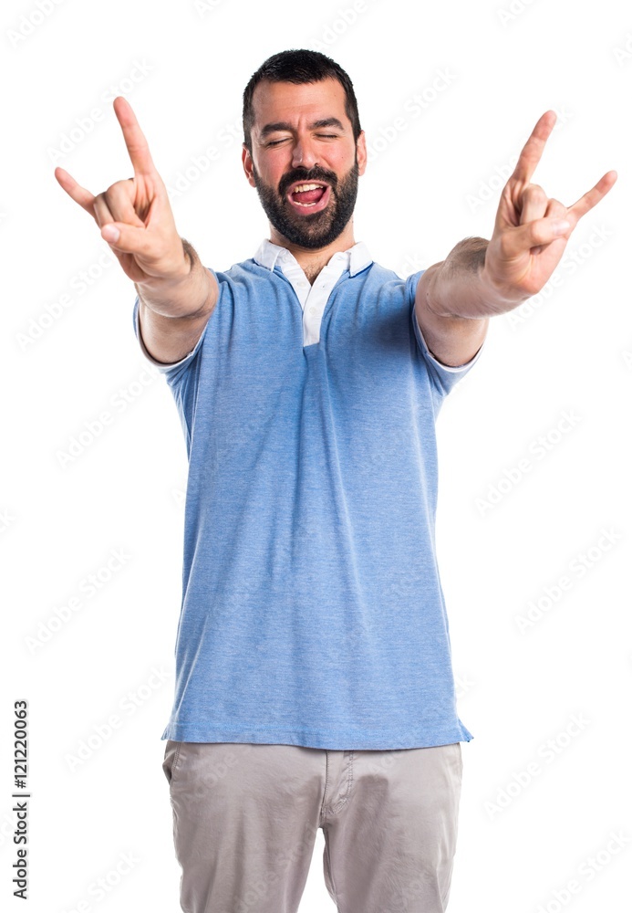 Man with blue shirt making horn gesture Man with blue shirt making horn gesture