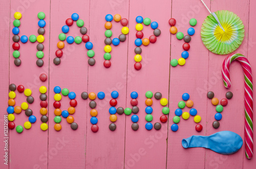 inscription from candies on a pink background