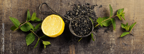 Fototapeta Naklejka Na Ścianę i Meble -  Dry tea with mint and lemon on wooden table