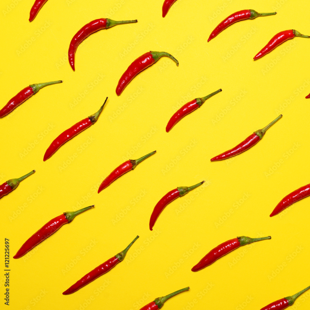 Red hot chili peppers on yellow background - Flat lay Red hot chili peppers on yellow background - Flat lay