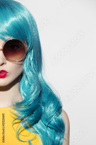 Pop art woman portrait wearing blue curly wig and sunglasses. Wh