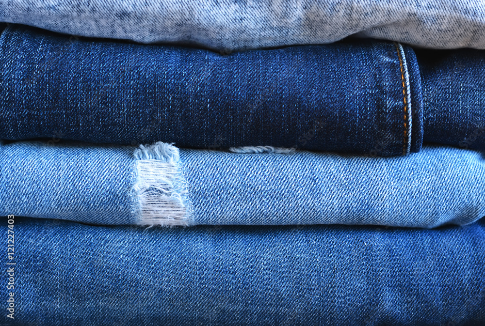 Fashionable and stylish clothes - a lot of different blue jeans