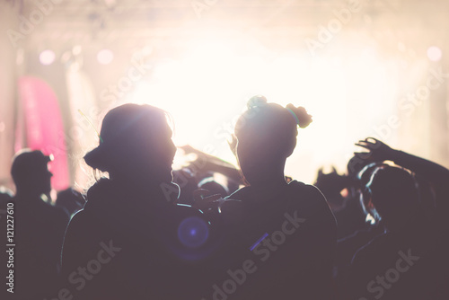 Silhouettes of happy people infront of a stage