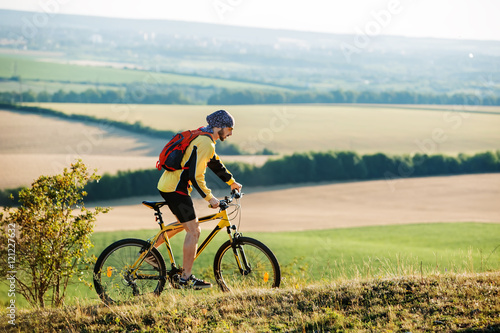 Young man cycling on a rural road