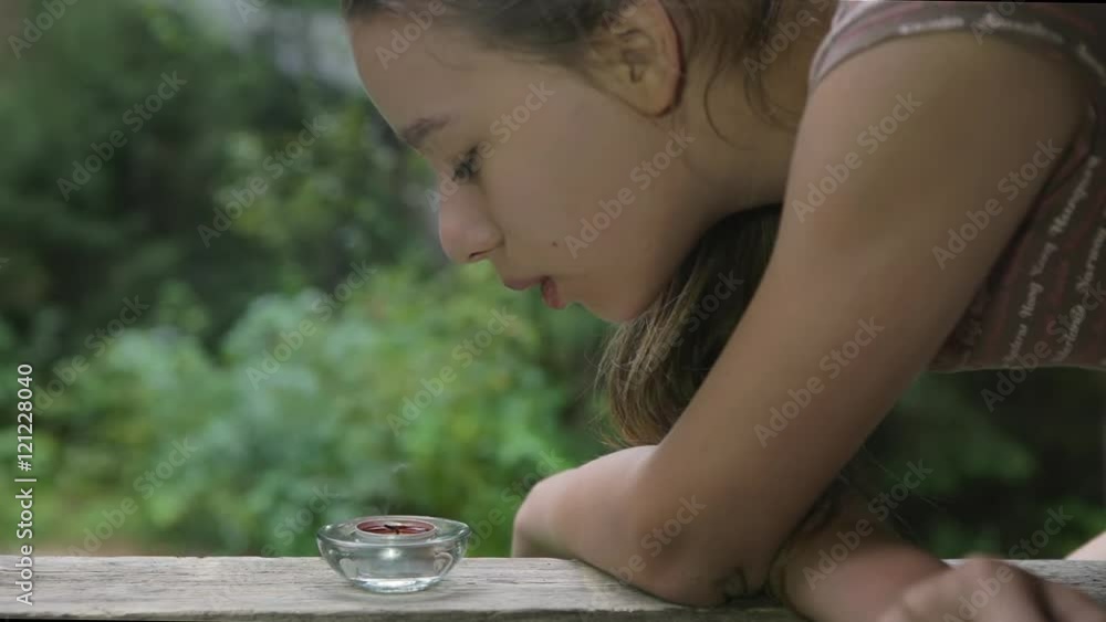Beautiful young girl is blowing the candle Beautiful young girl is blowing the candle