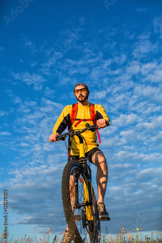 Young man cycling on a rural road