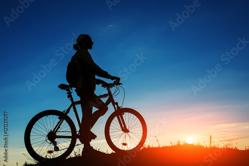 Fototapeta Naklejka Na Ścianę i Meble -  Silhouette of cyclist and a bike on sky background