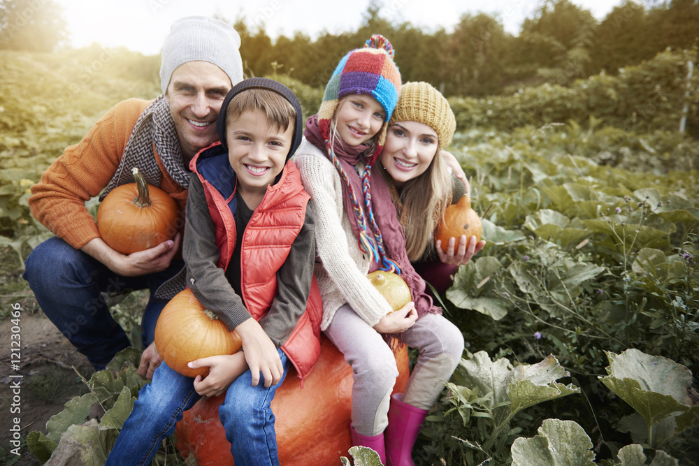 Happy family in the field full of pumpkin Happy family in the field full of pumpkin