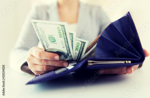 close up of woman hands with wallet and money