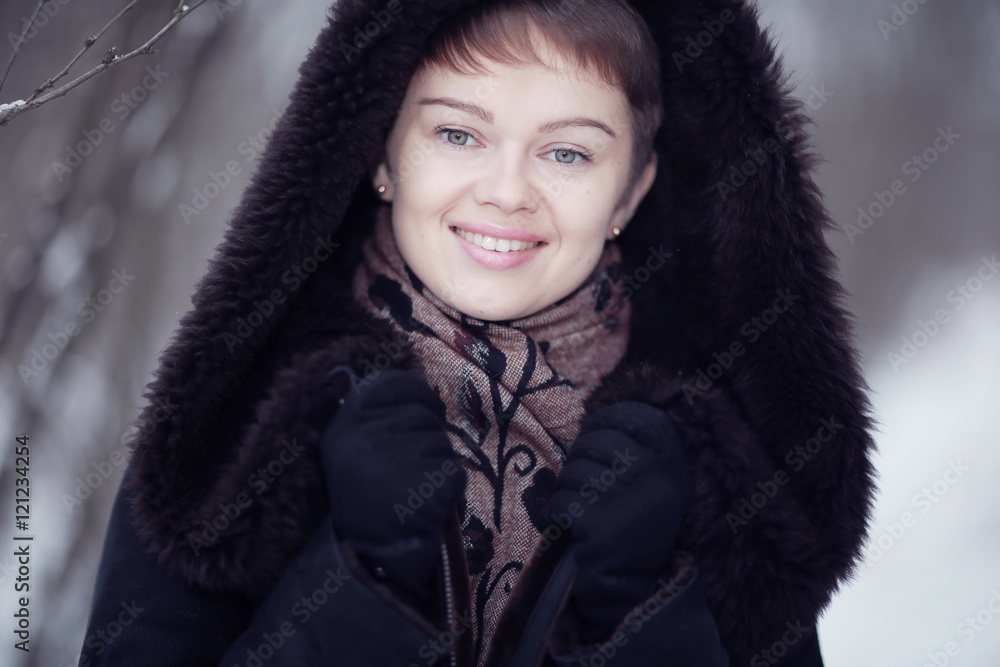 Winter woman in a fur coat on the snow outside Winter woman in a fur coat on the snow outside