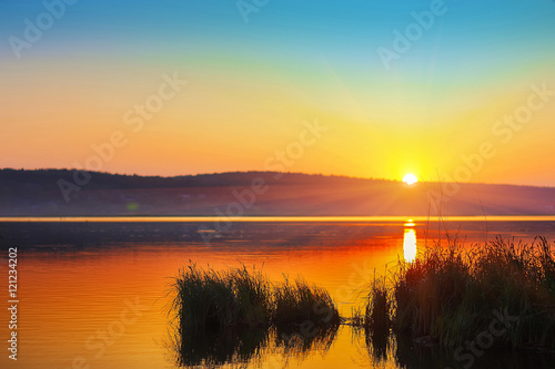 Beautiful sunset over calm lake. Dusk time