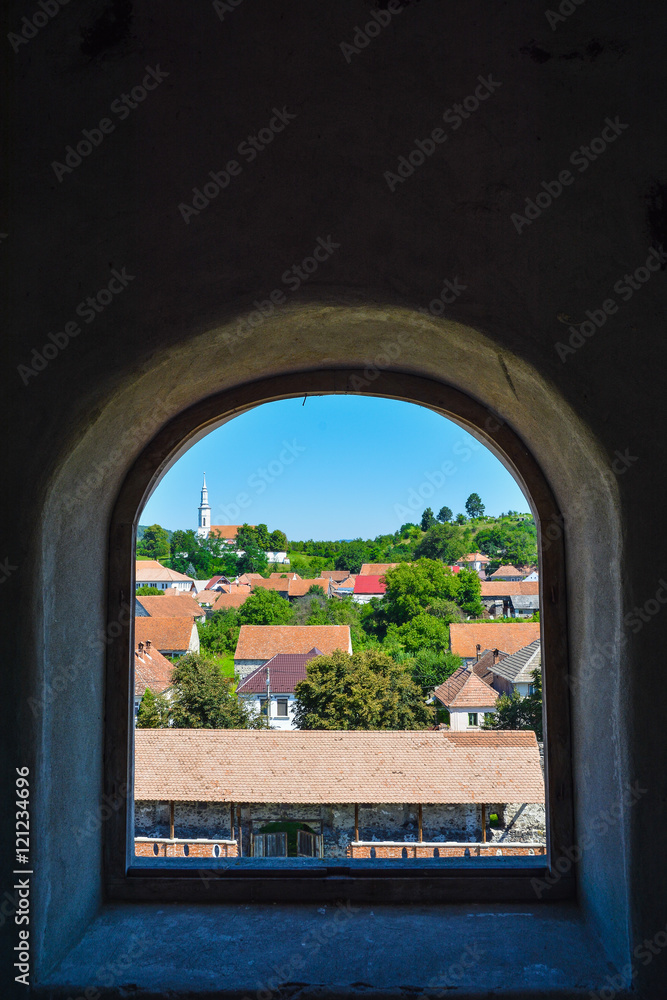 Beautiful view over Racos village from the citadel tower through the window, in Romania