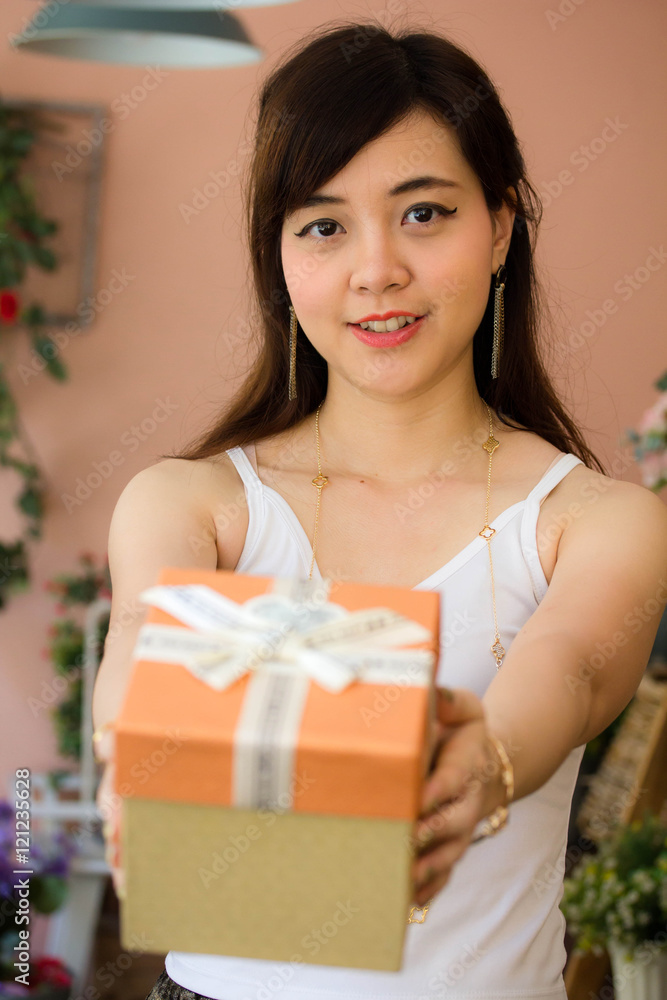 Portrait of thai women adult beautiful girl hold gift box in hands