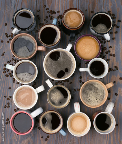 Obraz na plátně Many cups of coffee on wooden background, top view