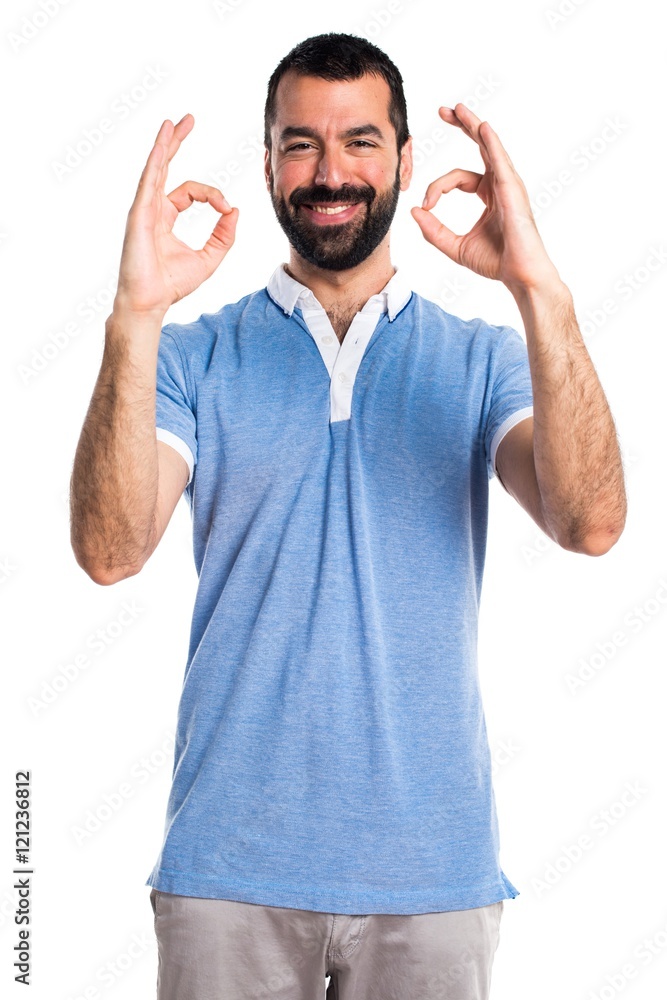 Fototapeta premium Man with blue shirt making OK sign
