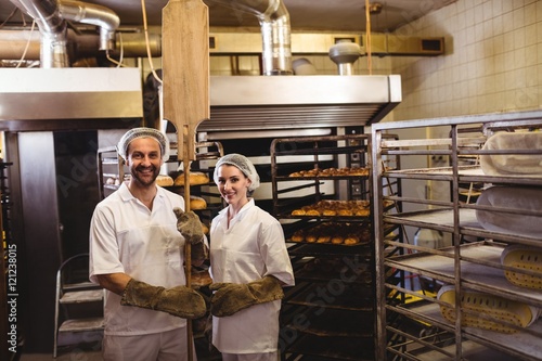 Portrait of female and male baker standing together